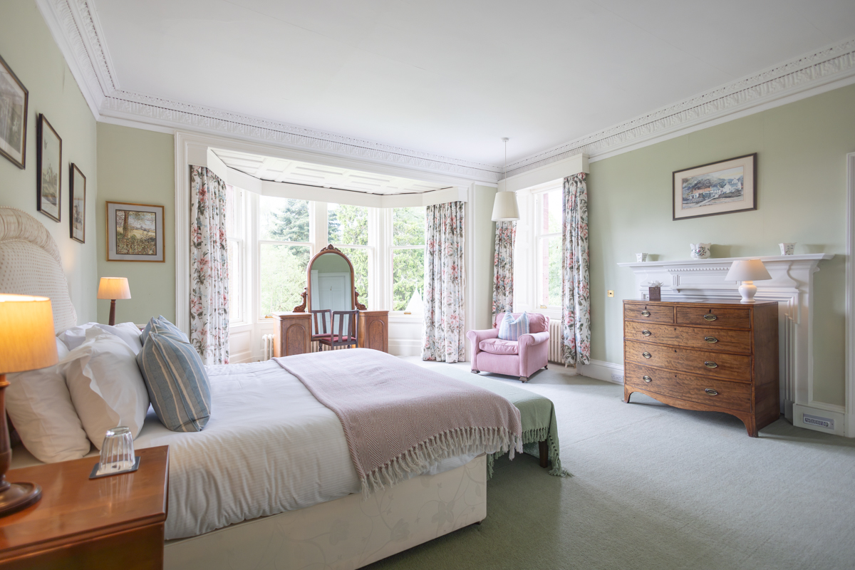 A light-filled guest bedroom overlooking the garden